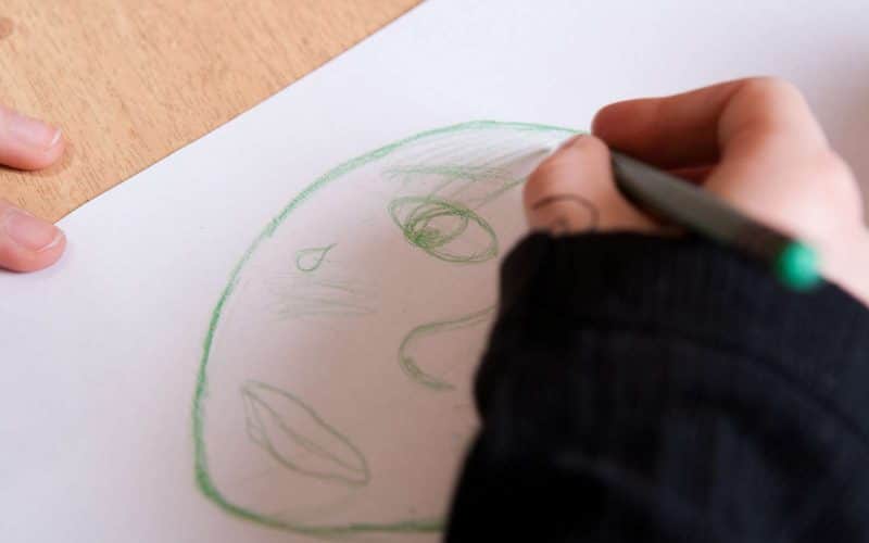 Barn tegner en tegning af et barn der græder